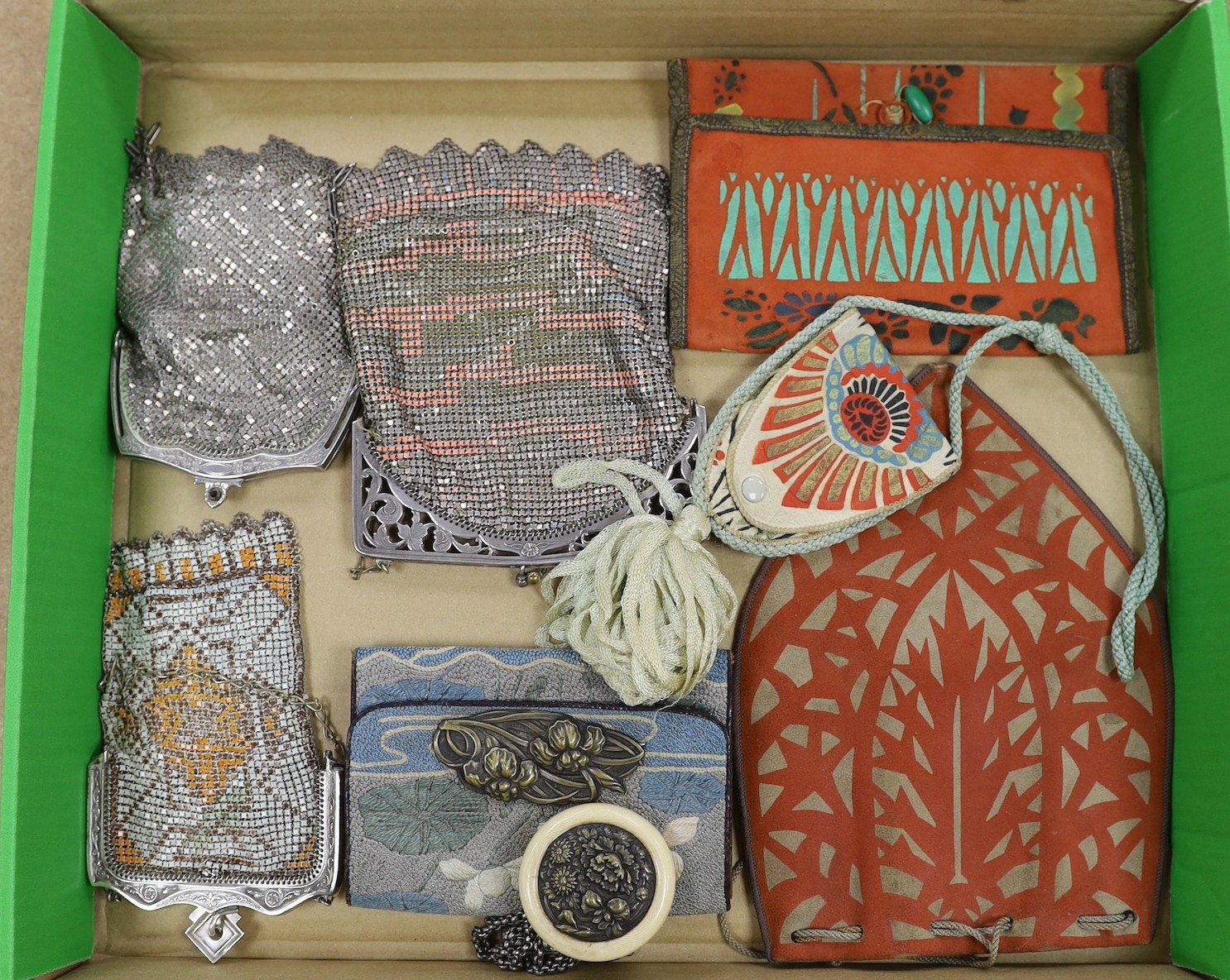 A group of unusual Art Deco bags: two hand printed suede purses and a similar bag, a Japanese embroidered purse to hang from an Obi and three ornate metal bags